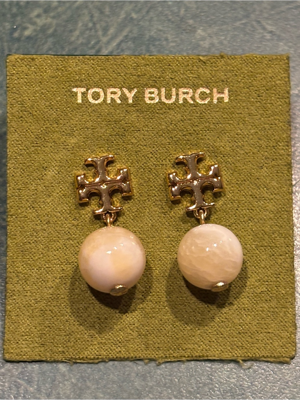 Brand new Tory Burch Gold plated Logo Drop Earrings with Cream Stone Spheres